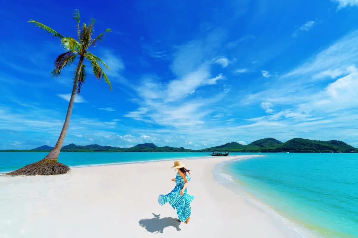 Woman running across Laem Had Beach, Koh Yao Yai, Phatthalung, Thailand